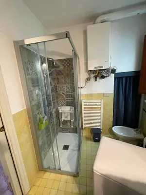 a shower stall in a bathroom with a sink at House Quattro Canti in Palermo
