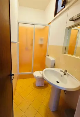 a bathroom with a toilet and a sink at Villetta Verde Mare - Scopello in Scopello
