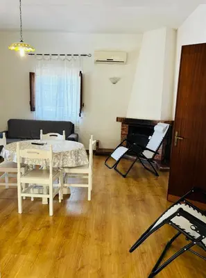 a living room with a table and a piano at Villetta Verde Mare - Scopello in Scopello
