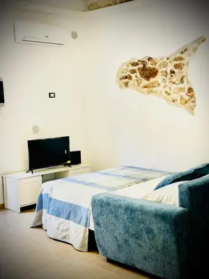 a bedroom with a bed and a fish head on the wall at Sicilia biedda casa vacanze in Terrasini