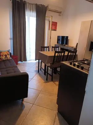 a living room with a table and a couch at House Ninì in Palermo