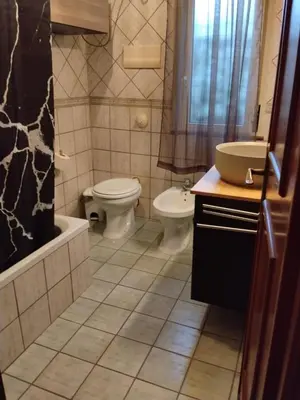 a kitchen with a stove and a sink at House Ninì in Palermo