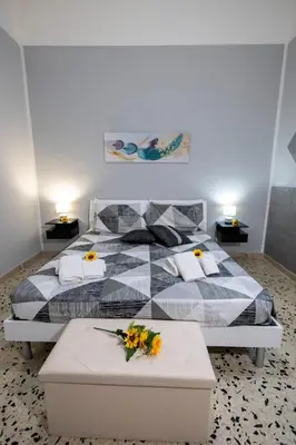a bedroom with a bed with flowers on it at Gioiello di casa in Palermo