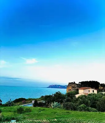 a house on a hill next to the ocean at Terrazza Vitaloca in Scopello