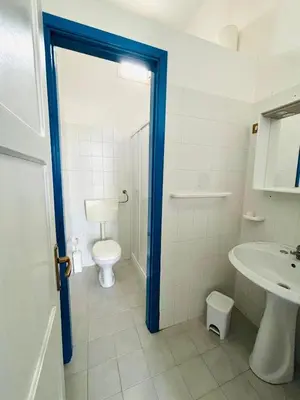 a bathroom with a toilet and a sink at Terrazza Vitaloca in Scopello