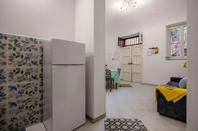 a kitchen with white cabinets and a stove top oven at La Castellana Apartments, vista panoramica sul mare, nel cuore storico di Carini, a due passi dal Duomo e dal castello in Carini