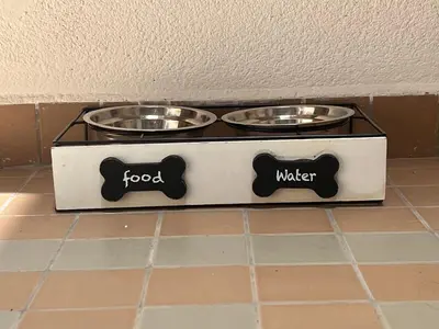 two feeding bowls in a box on the floor at A Casa Tua Palermo in Palermo