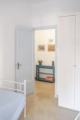 a bedroom with a bed and a door to a room at AL Qanat di Notarbartolo in Palermo