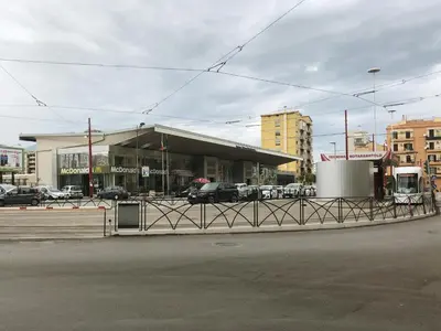 a parking lot with a gas station in a city at AL Qanat di Notarbartolo in Palermo