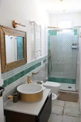 a bathroom with a sink and a toilet and a shower at Riad Casa Vacanze in Terrasini