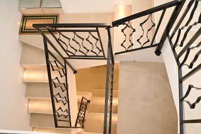 a stairwell with a black and white rail and stairs at Riad Casa Vacanze in Terrasini