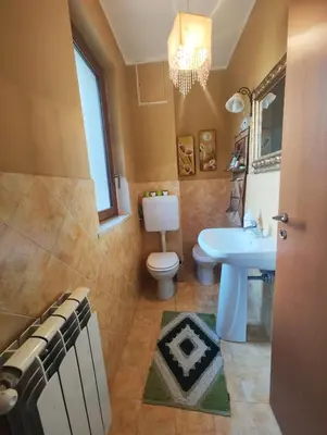 a bathroom with a toilet and a sink at Casa Carini - Villa Vacanze sul Mare con piscina idromassaggio in Carini