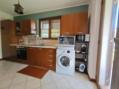 a kitchen with a washer and a washing machine at Casa Carini - Villa Vacanze sul Mare con piscina idromassaggio in Carini