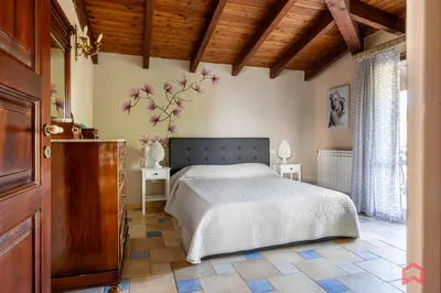 a bedroom with a bed and a wooden ceiling at Amazing Villa with pool & Jacuzzi in Balestrate