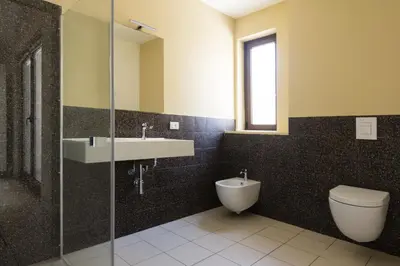 a bathroom with a sink and a toilet and a mirror at Visitsicilia Vasile 9 in Castellammare del Golfo