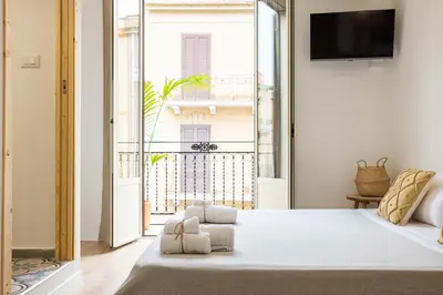 a bedroom with a bed and a balcony at Casa Marinù in Palermo