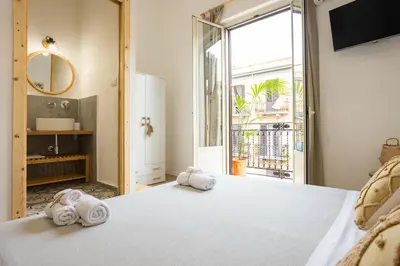 a bedroom with a bed and a large window at Casa Marinù in Palermo