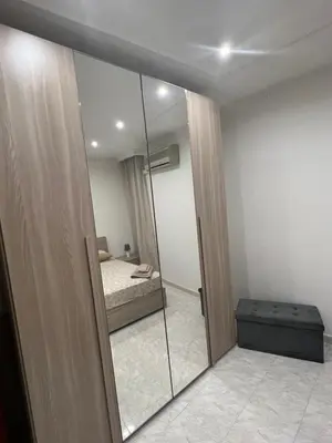 a room with a mirror and a bedroom with a bed at Ginevra House in Palermo