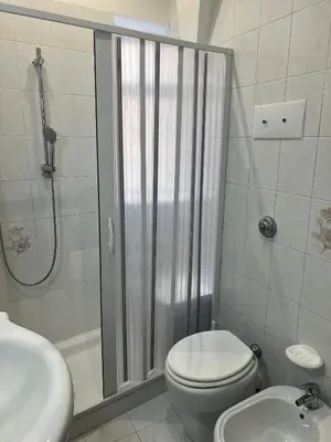 a bathroom with a shower and a toilet and a sink at Ginevra House in Palermo