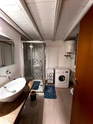 a bathroom with a sink and a washing machine at Sisidda Home in Palermo
