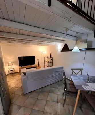a living room with a white couch and a television at Sisidda Home in Palermo