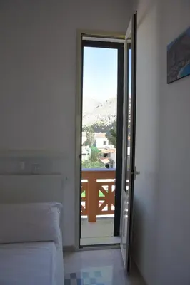 a bedroom with a sliding glass door to a balcony at apartment by the sea Mondello beach in Palermo