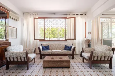 a living room with a couch and chairs and a table at Le Casette all'Addaura by Domus Sicily in Mondello