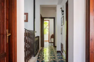 a hallway with a tile floor in a house at Le Casette all'Addaura by Domus Sicily in Mondello