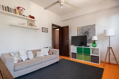 a living room with a couch and a flat screen tv at Le Casette all'Addaura by Domus Sicily in Mondello