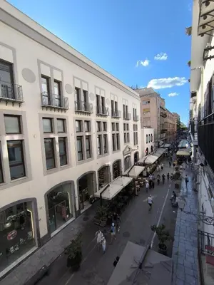 a city street with a group of buildings and people at Glocal flat Maqueda in Palermo