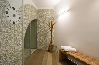 a bathroom with a clock on the wall and a bench at Trinacria Luxury Suite in Palermo