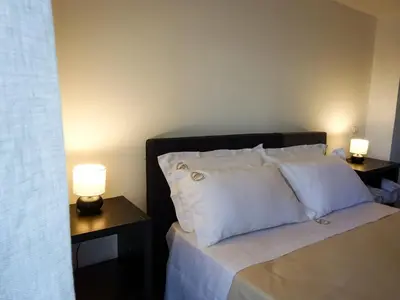 a bedroom with a bed with two lamps on tables at Sabatino Piazza Castelnuovo - Politeama in Palermo
