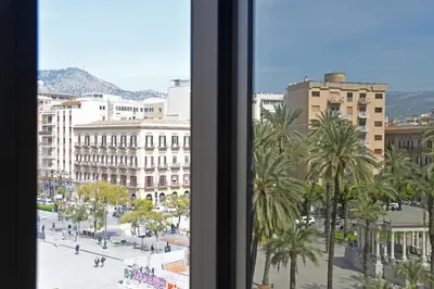 a view of a city with palm trees and buildings at Sabatino Piazza Castelnuovo - Politeama in Palermo