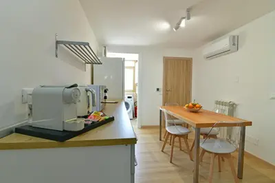 a kitchen with a counter with a table and a microwave at Sabatino Piazza Castelnuovo - Politeama in Palermo