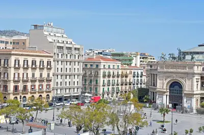 a group of buildings in a city with a street at Sabatino Piazza Castelnuovo - Politeama in Palermo
