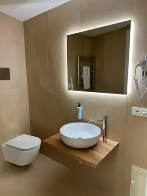 a bathroom with a sink and a toilet and a mirror at Sabatino Piazza Castelnuovo - Politeama in Palermo