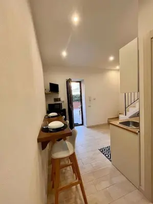 a small kitchen with a table and a counter top at Chicca House in Palermo