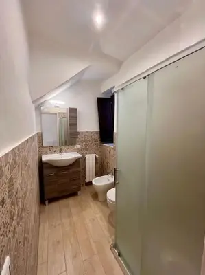 a bathroom with a shower and a toilet and a sink at Chicca House in Palermo