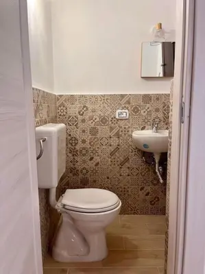 a bathroom with a toilet and a sink at Chicca House in Palermo