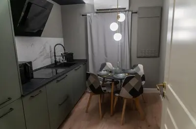 a kitchen with a table and chairs and a sink at Prestige in Palermo