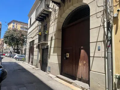 a large brown door on the side of a building at Prestige in Palermo