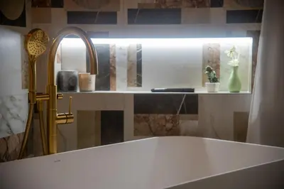 a bathroom with a tub and a mirror and a sink at Prestige in Palermo