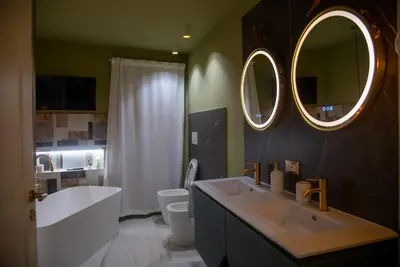 a bathroom with a sink and a toilet and a mirror at Prestige in Palermo