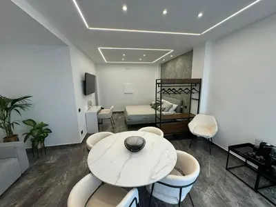 a room with a table and chairs and a bed at GRA' Suite Deluxe in Terrasini