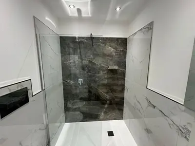 a bathroom with a shower with a glass door at GRA' Suite Deluxe in Terrasini