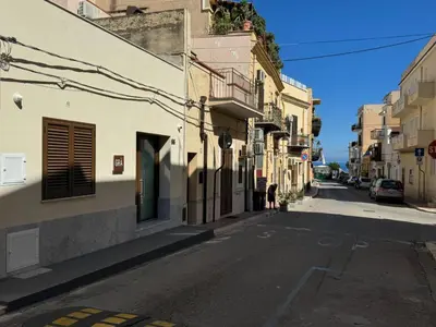 an empty street in a city with buildings at GRA' Suite Deluxe in Terrasini