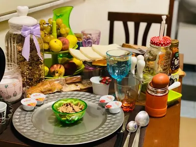 a table with a plate with a bowl of food at Casa ivan in Palermo