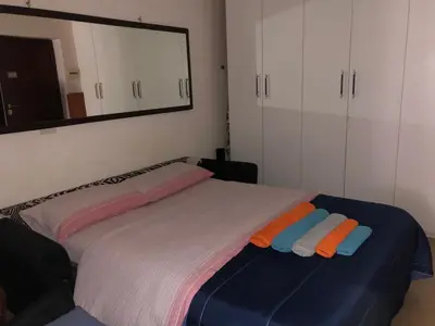 a bedroom with a large bed with towels on it at Casa ivan in Palermo