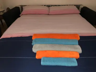 a bed with a bunch of towels on it at Casa ivan in Palermo