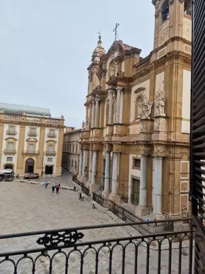 an old building with a clock tower in a courtyard at Vista San Domenico in Palermo